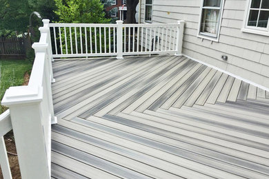 Example of a mid-sized mountain style backyard deck design in Boston
