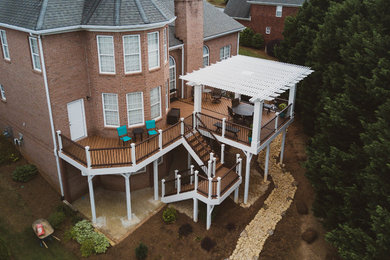 Mid-sized trendy backyard deck photo in Atlanta with a pergola