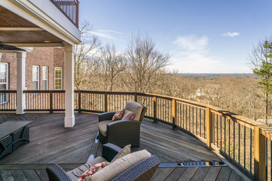 Huge elegant side yard deck photo in Atlanta with a roof extension