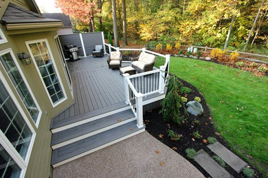 Mid-sized elegant backyard deck photo in Other with no cover