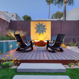 Photo of a large backyard deck in Phoenix with a fire feature and no cover.