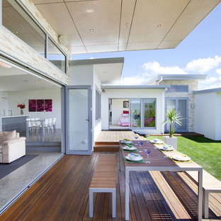 Deck - modern deck idea in Other with a roof extension
