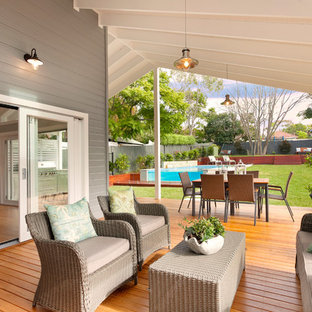This is an example of a country side yard deck in Central Coast with a roof extension.