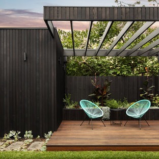 This is an example of a contemporary backyard deck in Melbourne with a pergola.