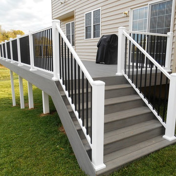 TimberTech deck in silver maple and white vinyl handrail with black round balust