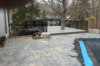 Large elegant side yard deck photo in Other