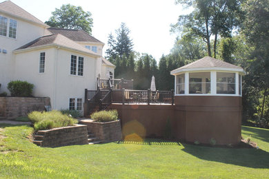 Inspiration for a mid-sized timeless backyard deck remodel in Philadelphia with a roof extension