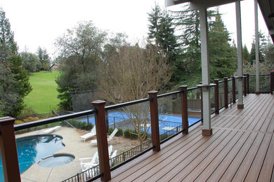 Mid-sized backyard deck photo in Sacramento with a roof extension