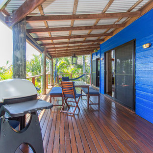 Réalisation d'une grande terrasse arrière ethnique avec des solutions pour vis-à-vis et une extension de toiture.