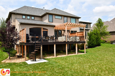 Inspiration for a contemporary backyard deck remodel in Kansas City with a pergola