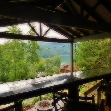 Two level deck on slope in the woods; view from upper level bar