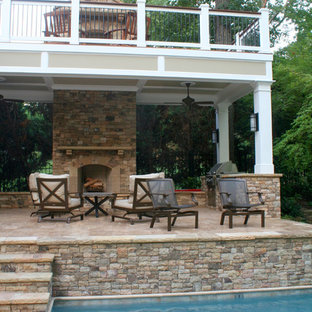 Deck - large traditional backyard deck idea in Atlanta with a fireplace and a roof extension