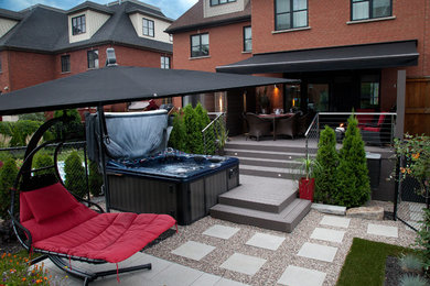 Diseño de terraza contemporánea pequeña en patio trasero con toldo