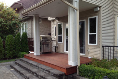 Deck - small traditional backyard deck idea in Vancouver with a roof extension