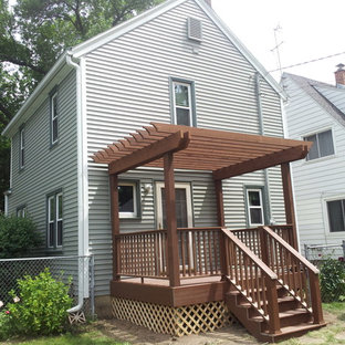 Example of a small arts and crafts backyard deck design in Other with a pergola