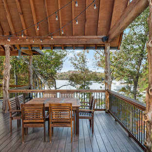 Example of a mountain style deck design in Other with a roof extension