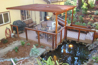 Water fountain deck - mid-sized modern backyard water fountain deck idea in Other with a pergola