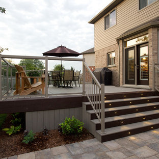 Example of a large trendy backyard deck skirting design in Toronto with no cover