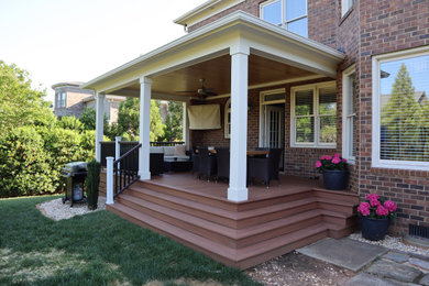 Deck - large backyard deck idea in Charlotte with a roof extension