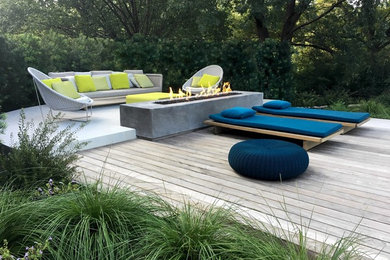 Example of a trendy backyard deck design in Dallas with a fireplace and no cover