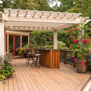 Deck container garden - mid-sized contemporary backyard deck container garden idea in New York with a pergola