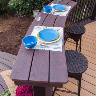 Deck container garden - mid-sized contemporary backyard deck container garden idea in Seattle with a pergola