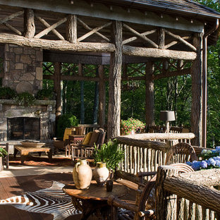 Deck - large rustic backyard deck idea in Atlanta with a fire pit and a roof extension