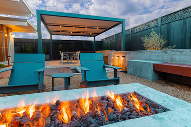Medium sized modern back patio in San Francisco with a fire feature and a pergola.