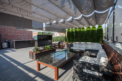 Example of a minimalist rooftop deck design in Chicago with a pergola