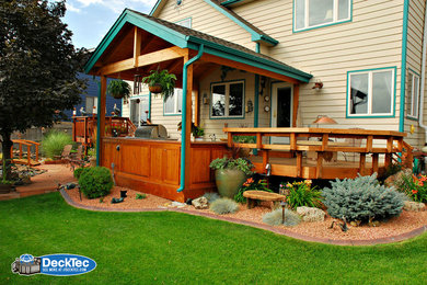 Inspiration for a modern backyard outdoor kitchen deck remodel in Denver with a roof extension