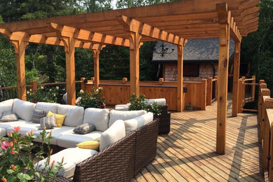 Inspiration for a large rustic back terrace in Other with a dock and a pergola.