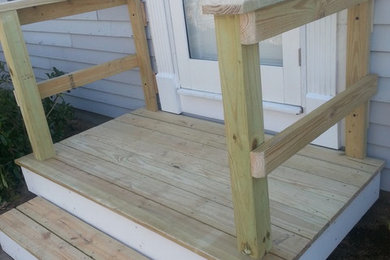 Example of a small mountain style backyard deck design in Boston with no cover