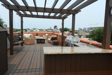 Large trendy rooftop outdoor kitchen deck photo in Chicago with a pergola
