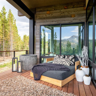 Example of a mountain style deck design in Other with a roof extension