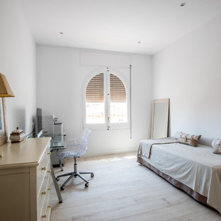 Foto de despacho mediterráneo con paredes blancas, suelo de madera clara, escritorio independiente y suelo beige