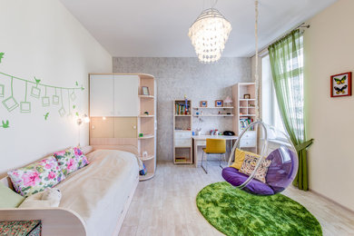 Cette image montre une chambre de fille de 4 à 10 ans design de taille moyenne avec un bureau, un mur beige et un sol en liège.