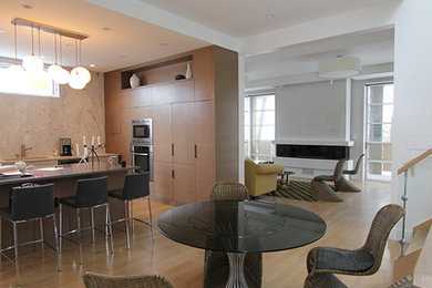 Trendy medium tone wood floor kitchen/dining room combo photo in Ottawa with white walls