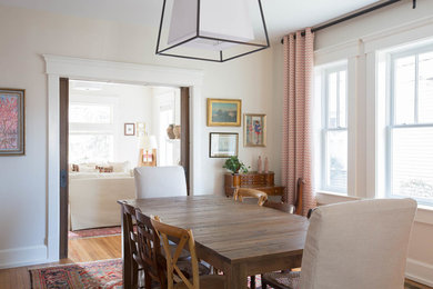 Example of a mid-sized eclectic brown floor dining room design in Columbus with white walls