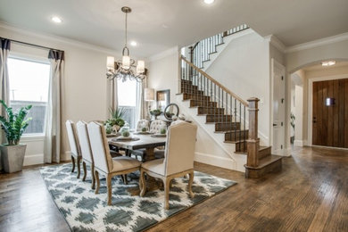 Example of a mid-sized trendy medium tone wood floor kitchen/dining room combo design in Dallas with white walls