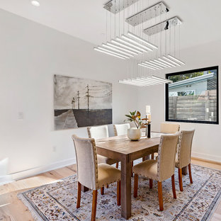 Example of a large trendy light wood floor great room design in Austin with white walls and no fireplace