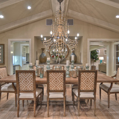 Example of a beach style medium tone wood floor dining room design in Los Angeles with beige walls