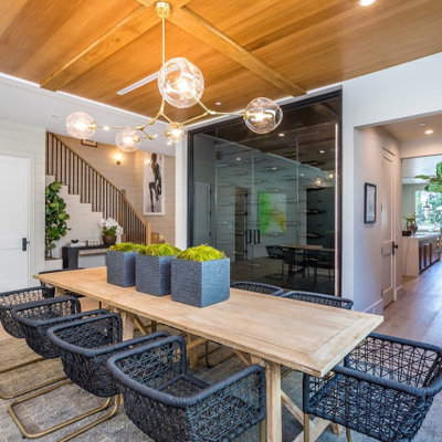 Inspiration for a large country light wood floor and beige floor enclosed dining room remodel with white walls and no fireplace