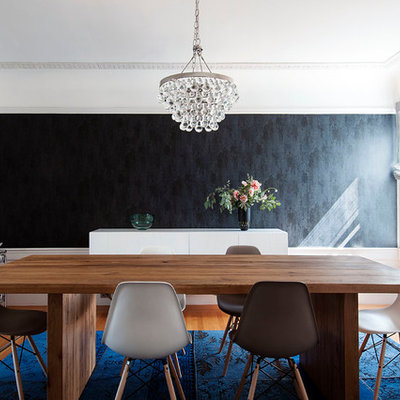 Enclosed dining room - mid-sized transitional medium tone wood floor and brown floor enclosed dining room idea in Los Angeles with white walls, a standard fireplace and a brick fireplace