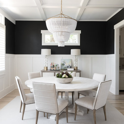 Inspiration for a transitional light wood floor and beige floor enclosed dining room remodel in Charlotte with black walls