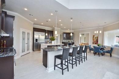 Kitchen/dining room combo - large contemporary concrete floor and gray floor kitchen/dining room combo idea in Orlando with beige walls and no fireplace