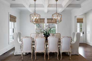 Inspiration for a coastal dining room in Charleston with white walls and dark hardwood flooring.