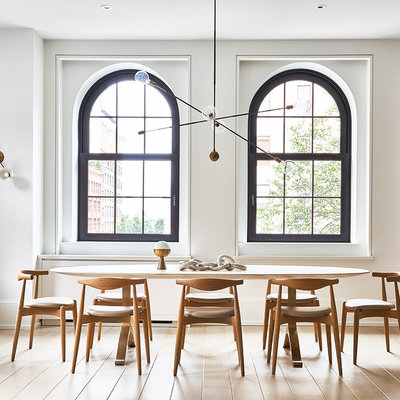 Inspiration for a scandinavian light wood floor and beige floor great room remodel in New York with white walls and no fireplace