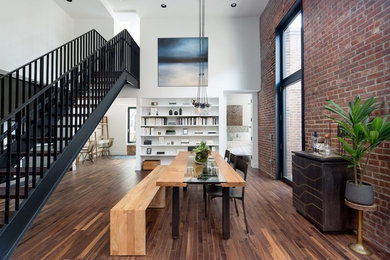Example of a mid-sized urban dark wood floor and brown floor great room design in New York with multicolored walls