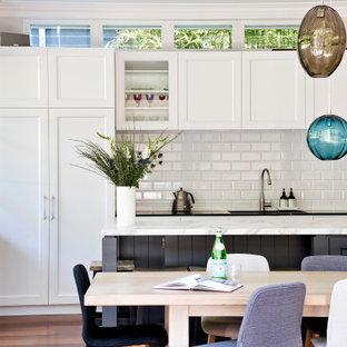 Large transitional kitchen/dining combo in Sydney with brown floor.