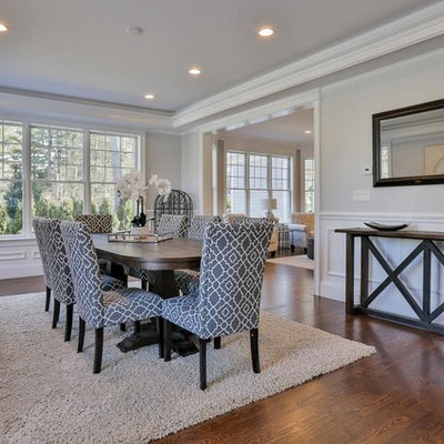 Large transitional medium tone wood floor and brown floor enclosed dining room photo in Boston with gray walls and no fireplace